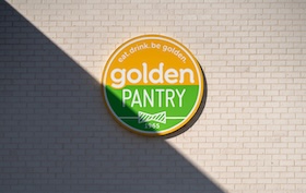 Golden Pantry logo on brick wall